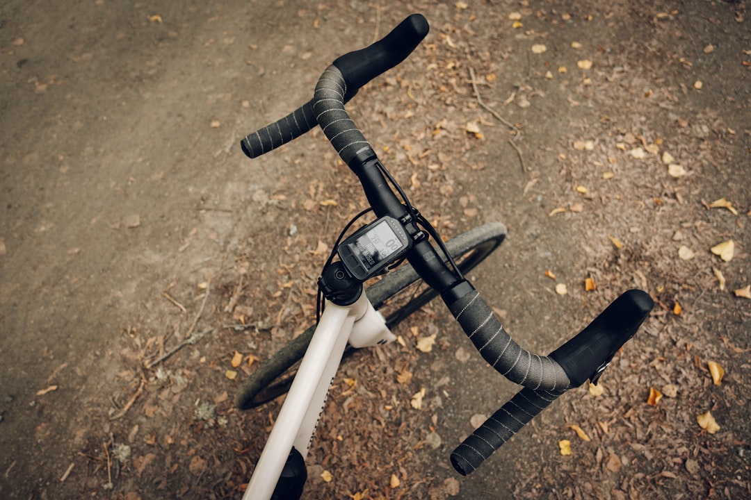 Close-up of a cyclist pedaling on a road bike with a power meter visible.