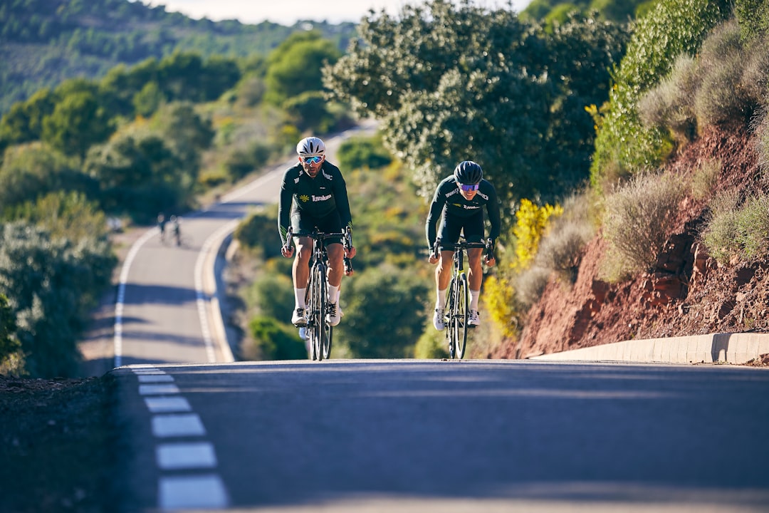 Group of road cyclists riding together outdoors on paved roads.
