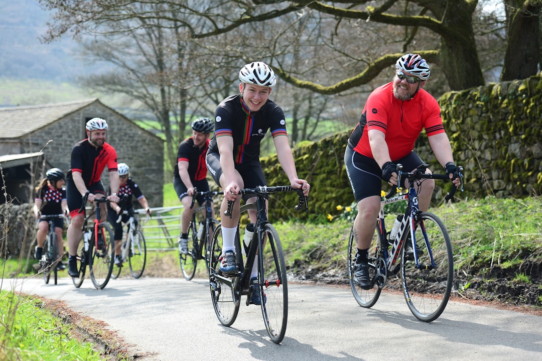 Group of road cyclists riding together outdoors on paved roads.