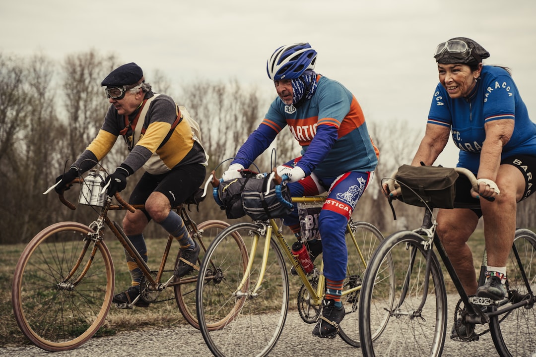 Group of road cyclists riding together outdoors on paved roads.