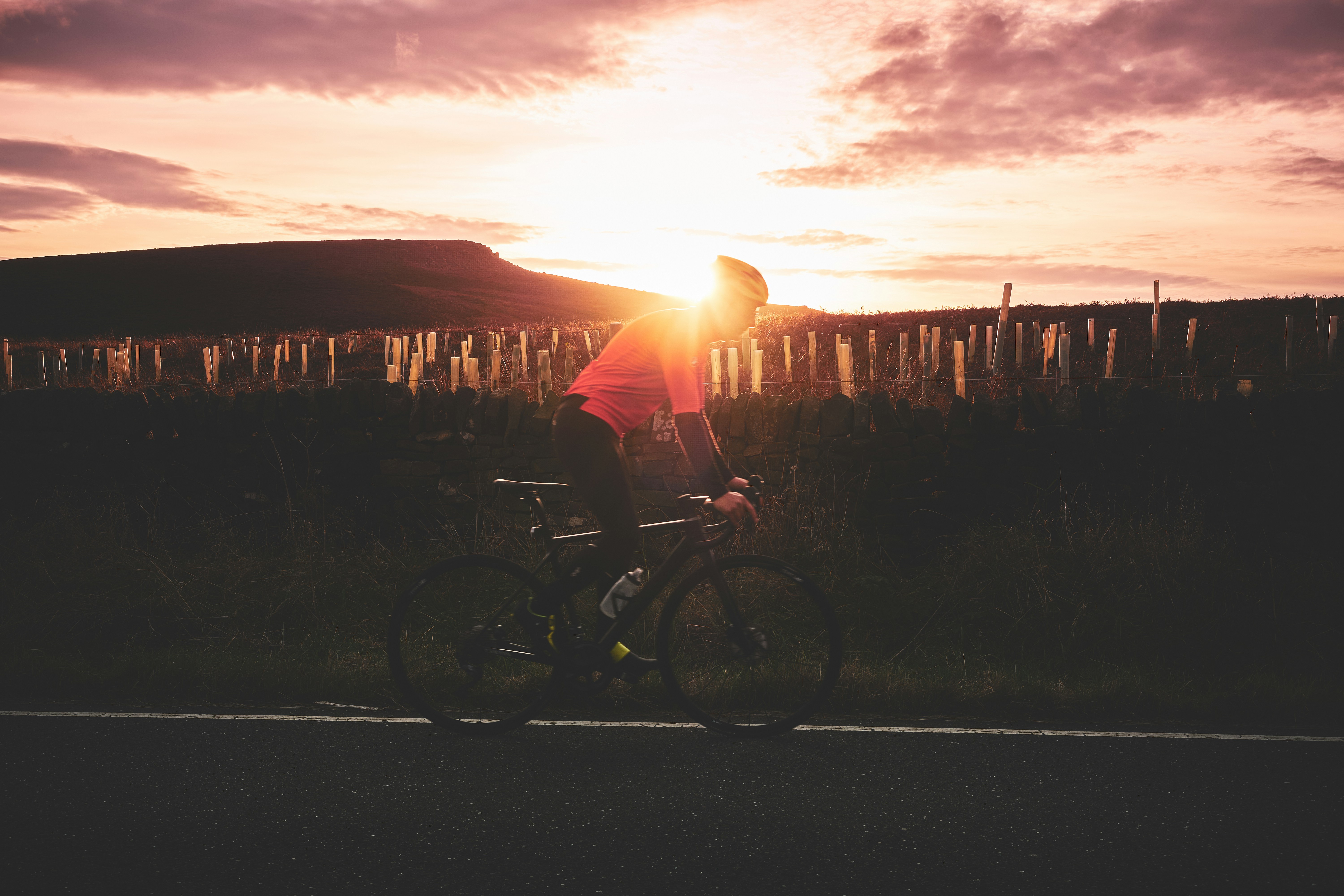 Cyclist riding a road bike outdoors in real conditions.