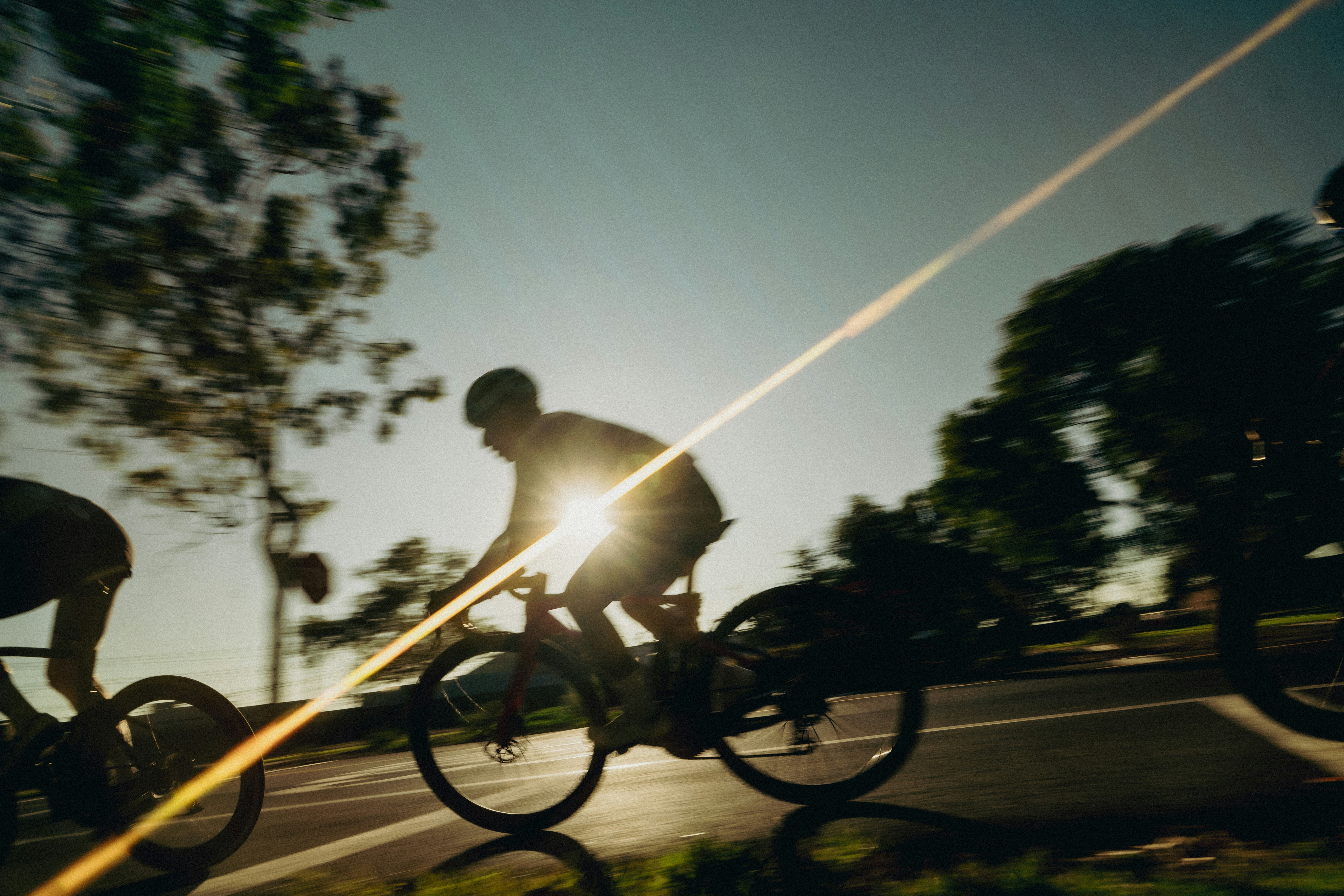 Cyclist riding a road bike outdoors in real conditions.