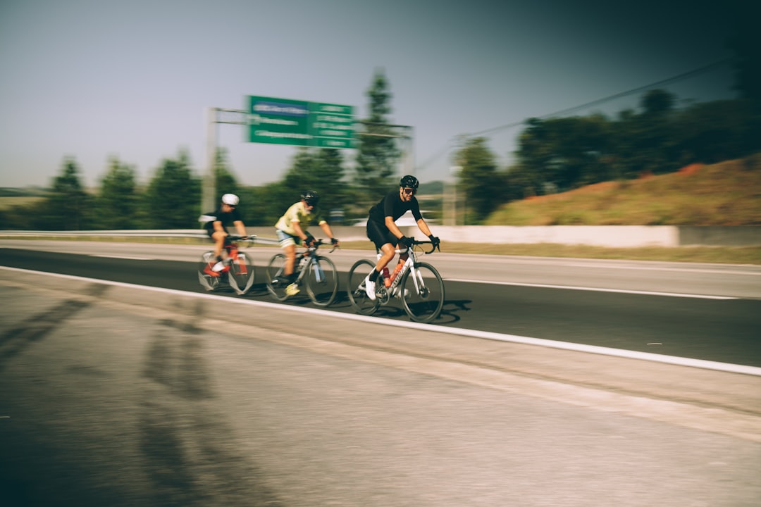 Group of road cyclists riding together outdoors on paved roads.
