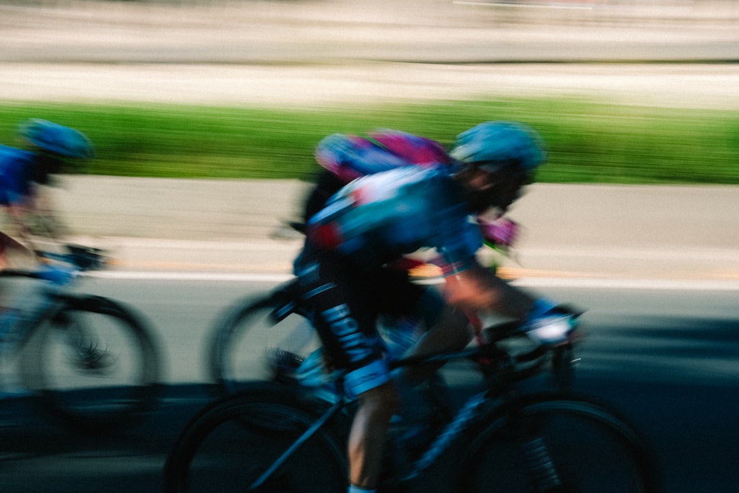Group of road cyclists riding together outdoors on paved roads.