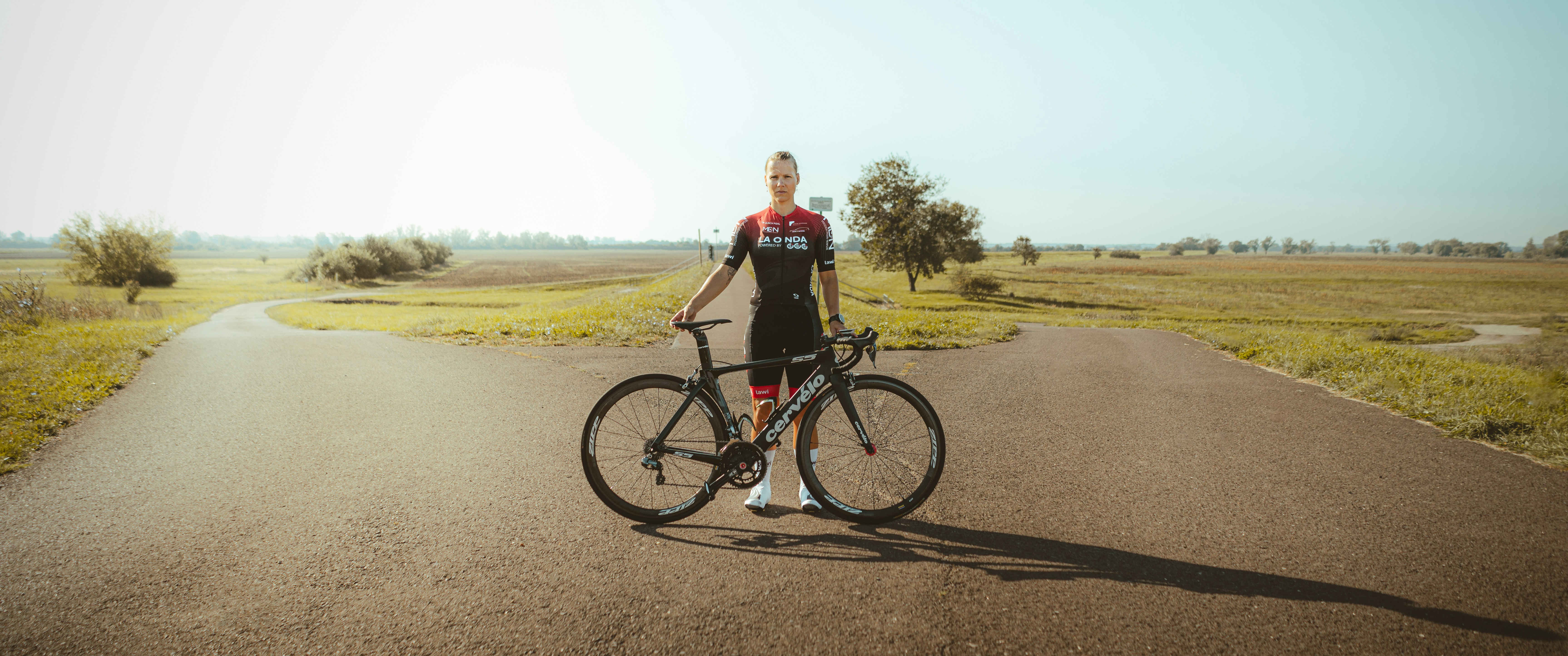 Cyclist riding a road bike outdoors in real conditions.