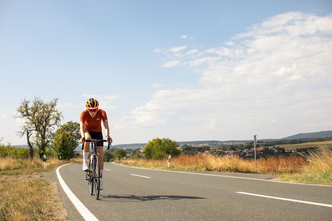 Group of road cyclists riding together outdoors on paved roads.