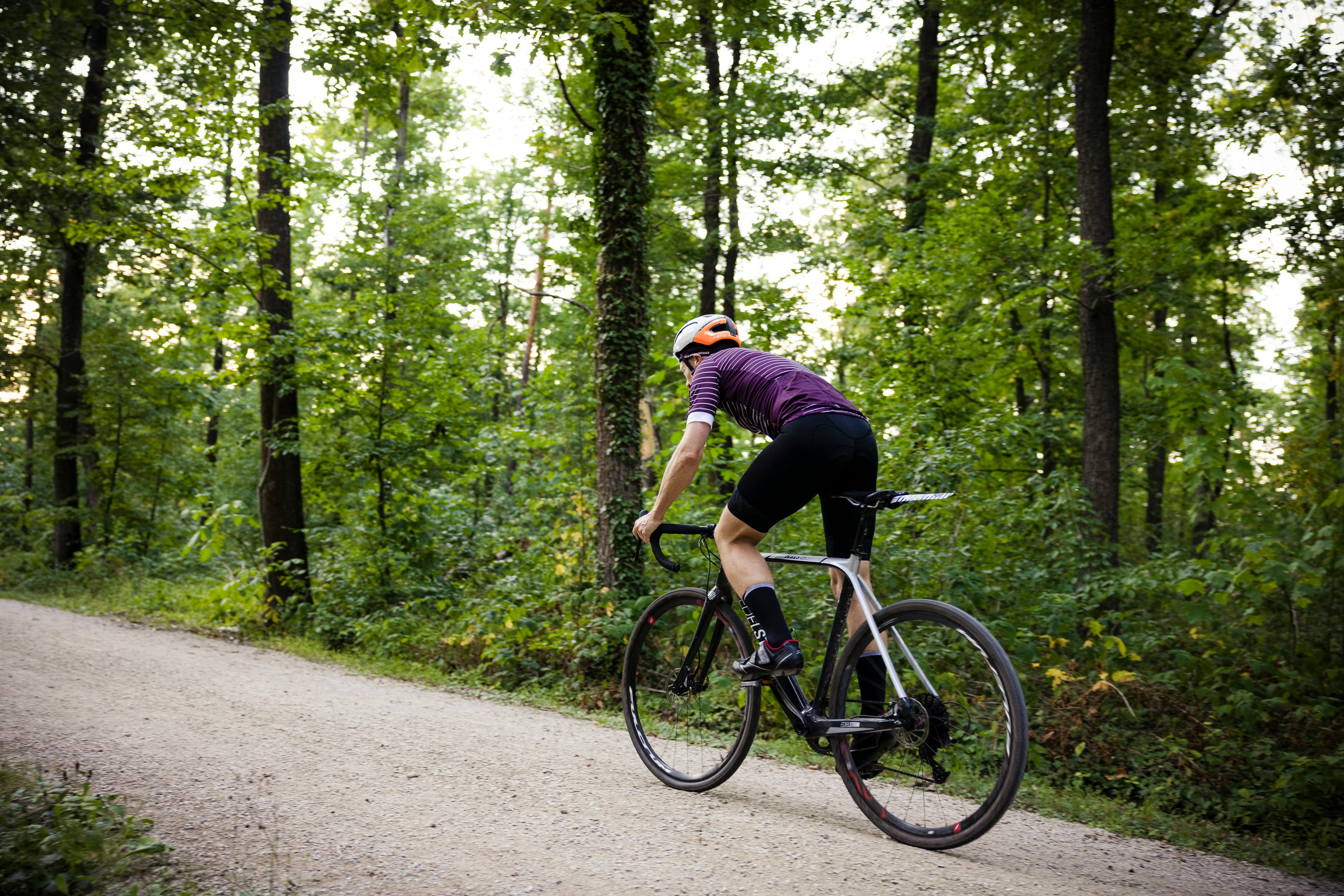 Cyclist riding a road bike outdoors in real conditions.