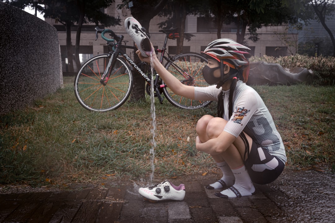 Close-up of a cyclist pedaling on a road bike with a power meter visible.