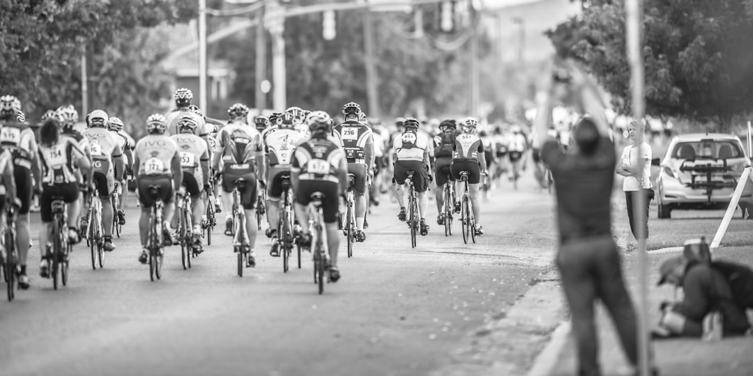 Group of road cyclists riding together outdoors on paved roads.