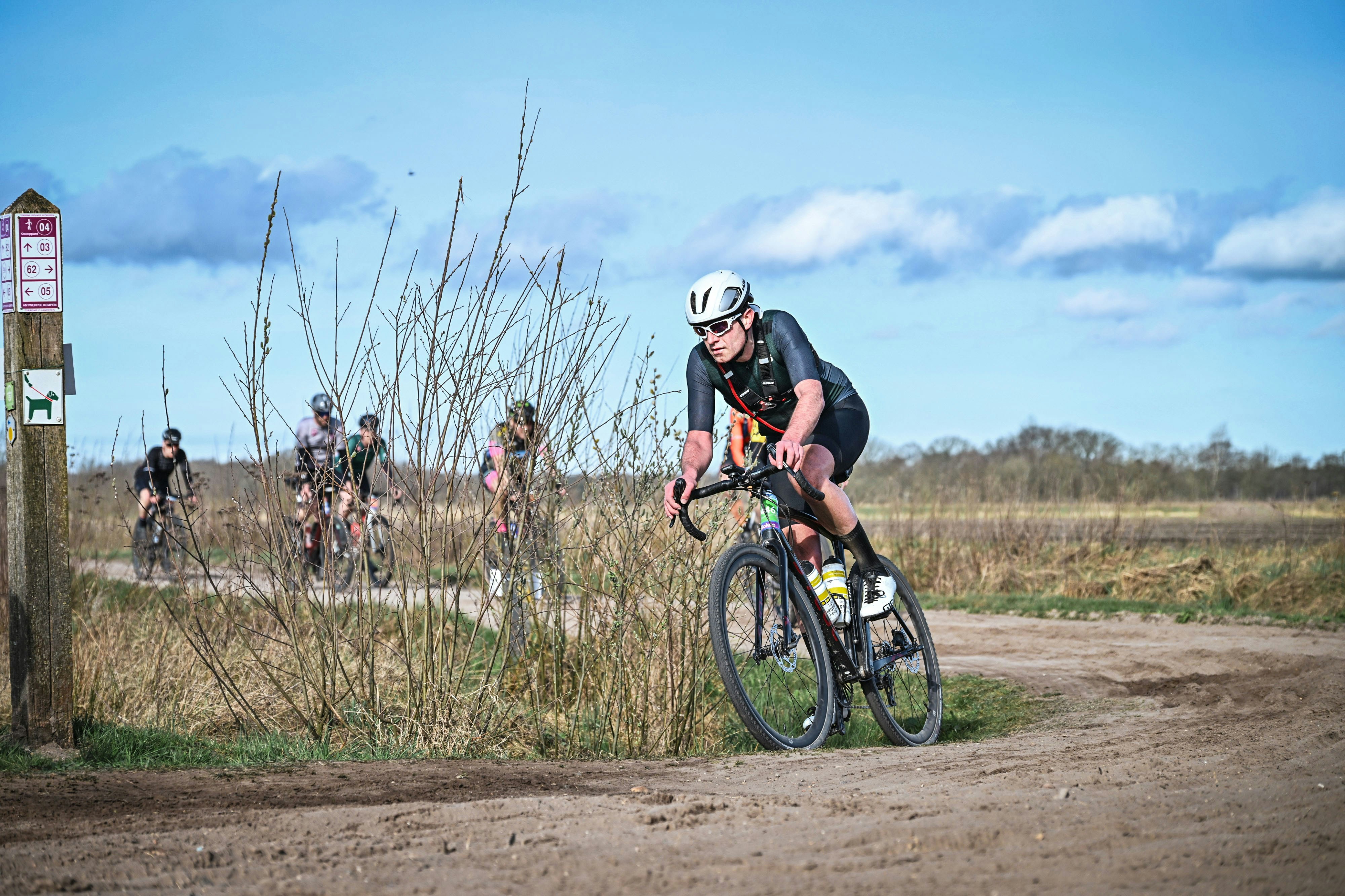 Cyclist riding a road bike outdoors in real conditions.