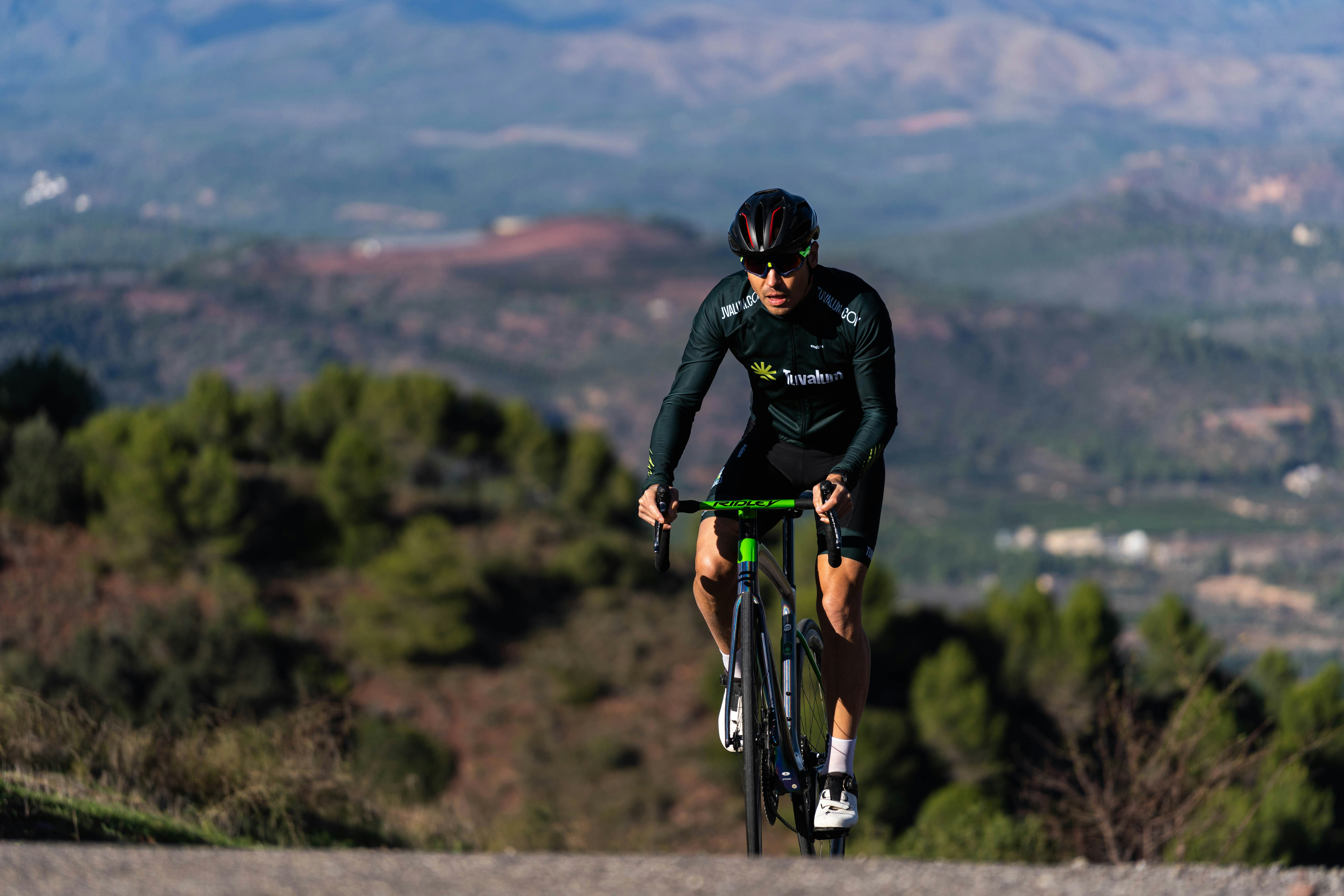 Cyclist riding a road bike outdoors in real conditions.