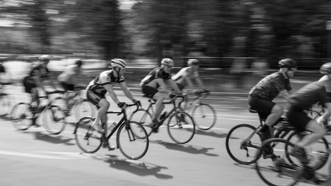 Group of road cyclists riding together outdoors on paved roads.