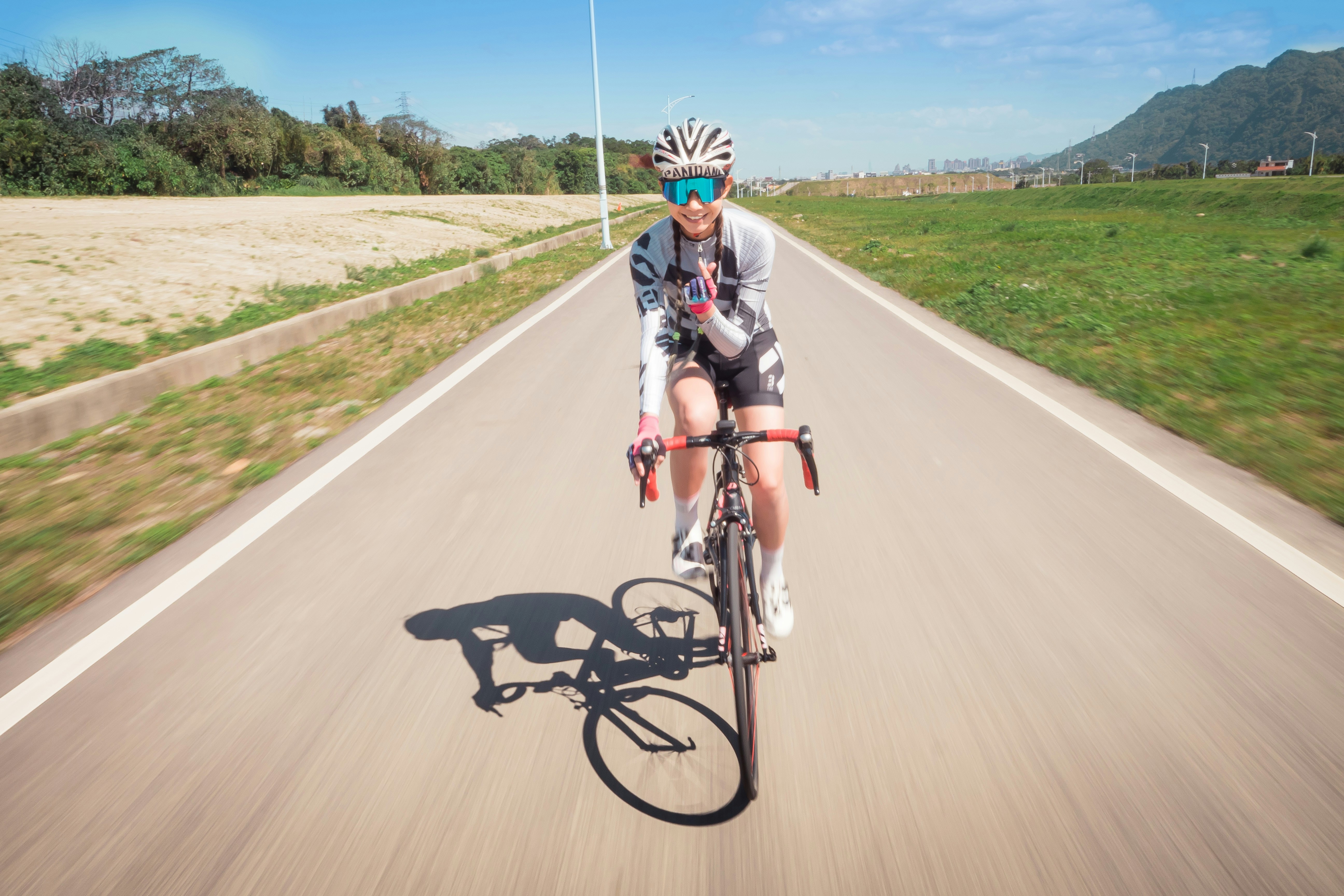 Cyclist riding a road bike outdoors in real conditions.