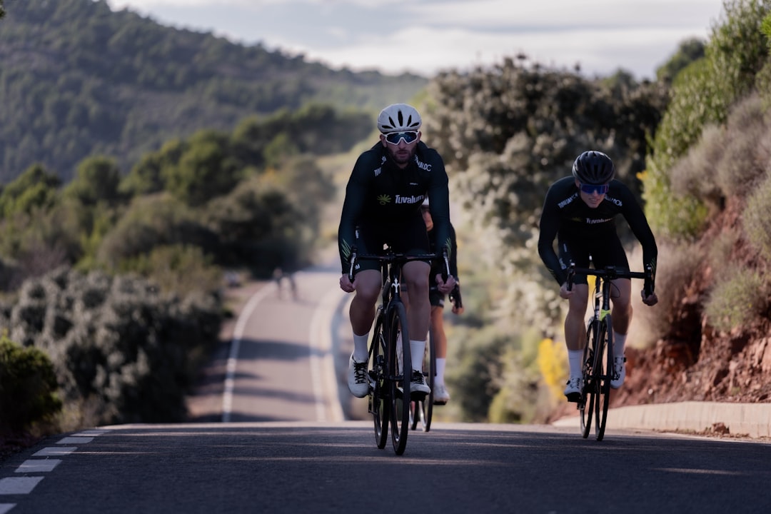 Group of road cyclists riding together outdoors on paved roads.
