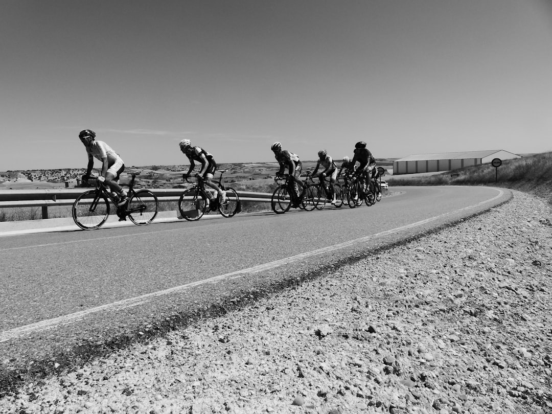 Group of road cyclists riding together outdoors on paved roads.