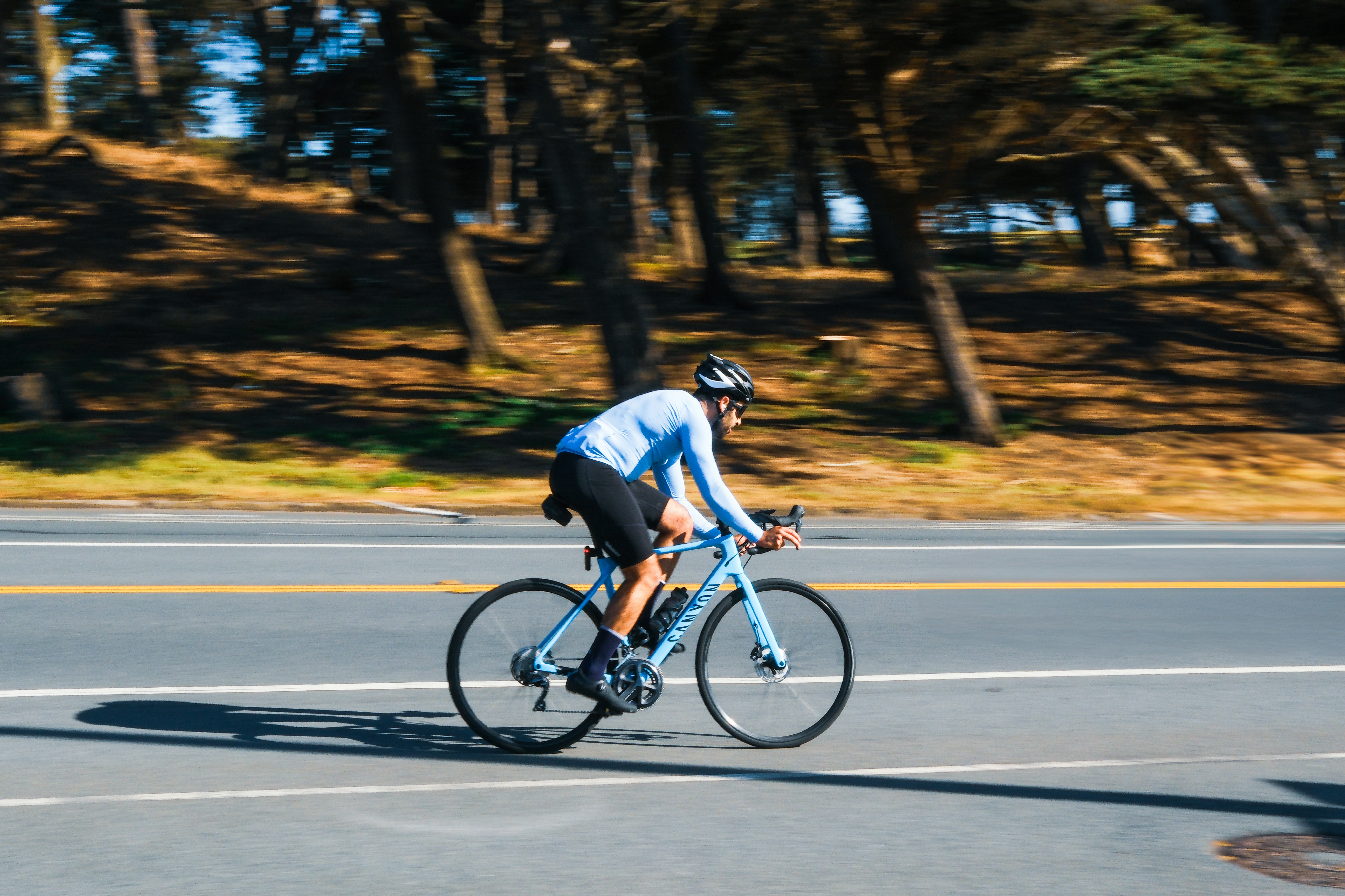 Cyclist riding a road bike outdoors in real conditions.