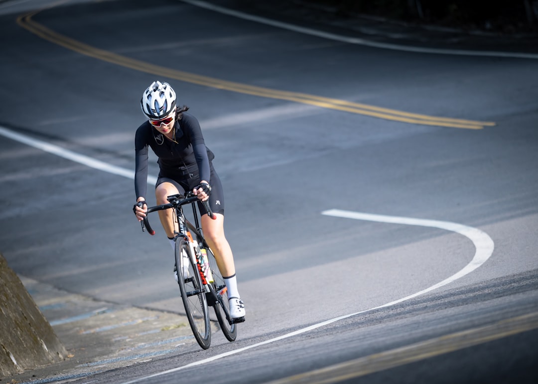 Group of road cyclists riding together outdoors on paved roads.
