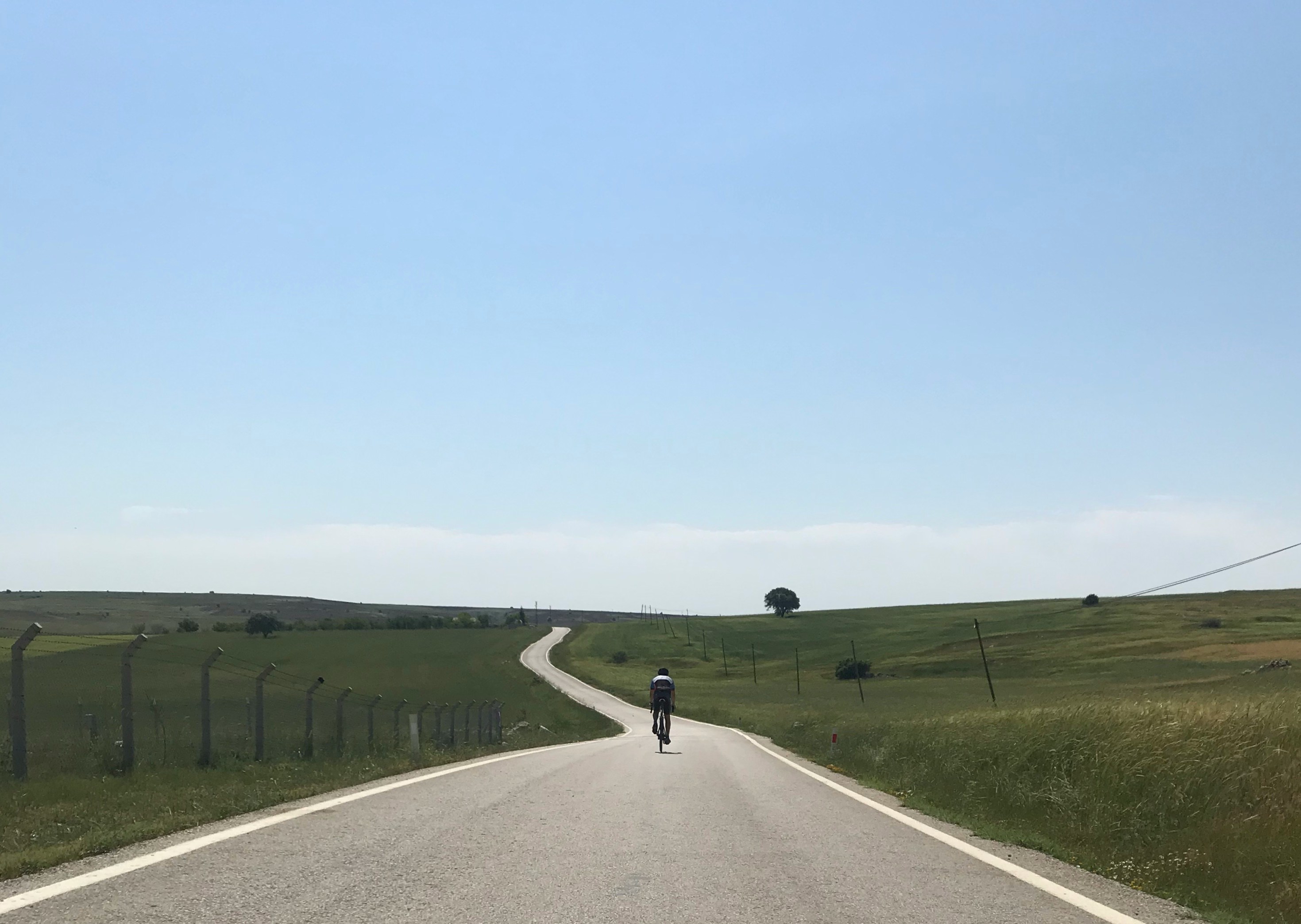 Cyclist riding a road bike outdoors in real conditions.