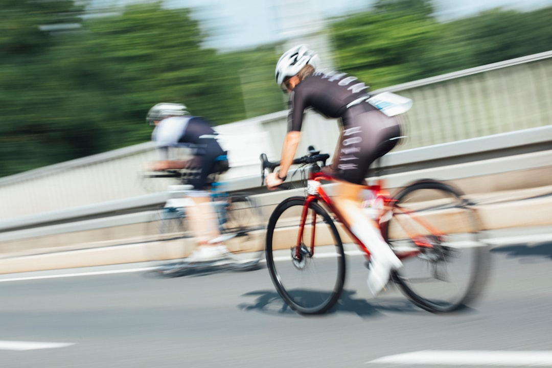 Group of road cyclists riding together outdoors on paved roads.
