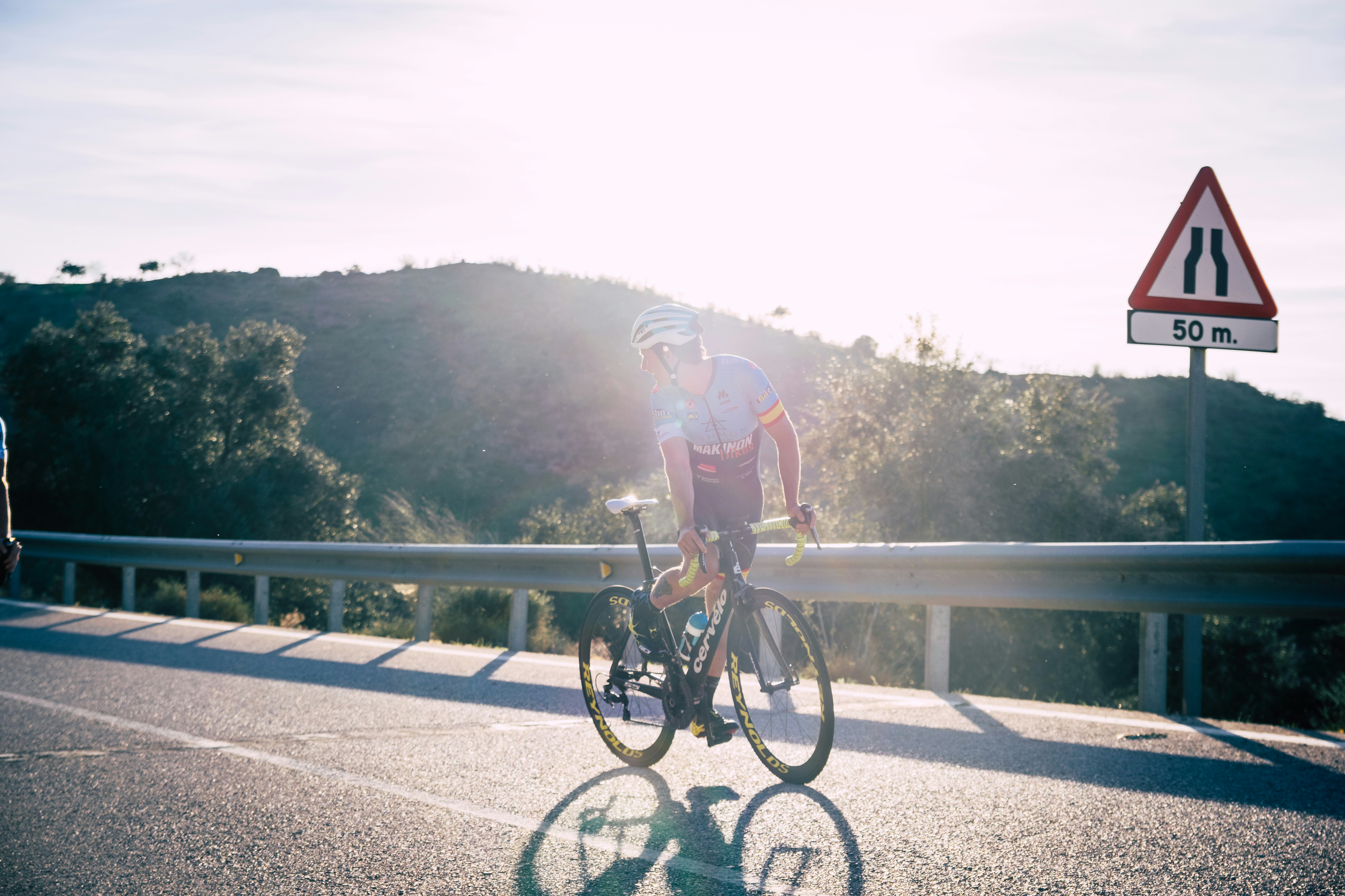 Cyclist riding a road bike outdoors in real conditions.