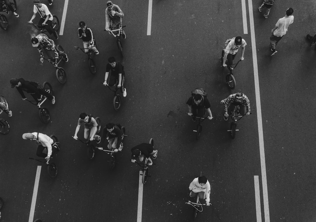 Group of road cyclists riding together outdoors on paved roads.