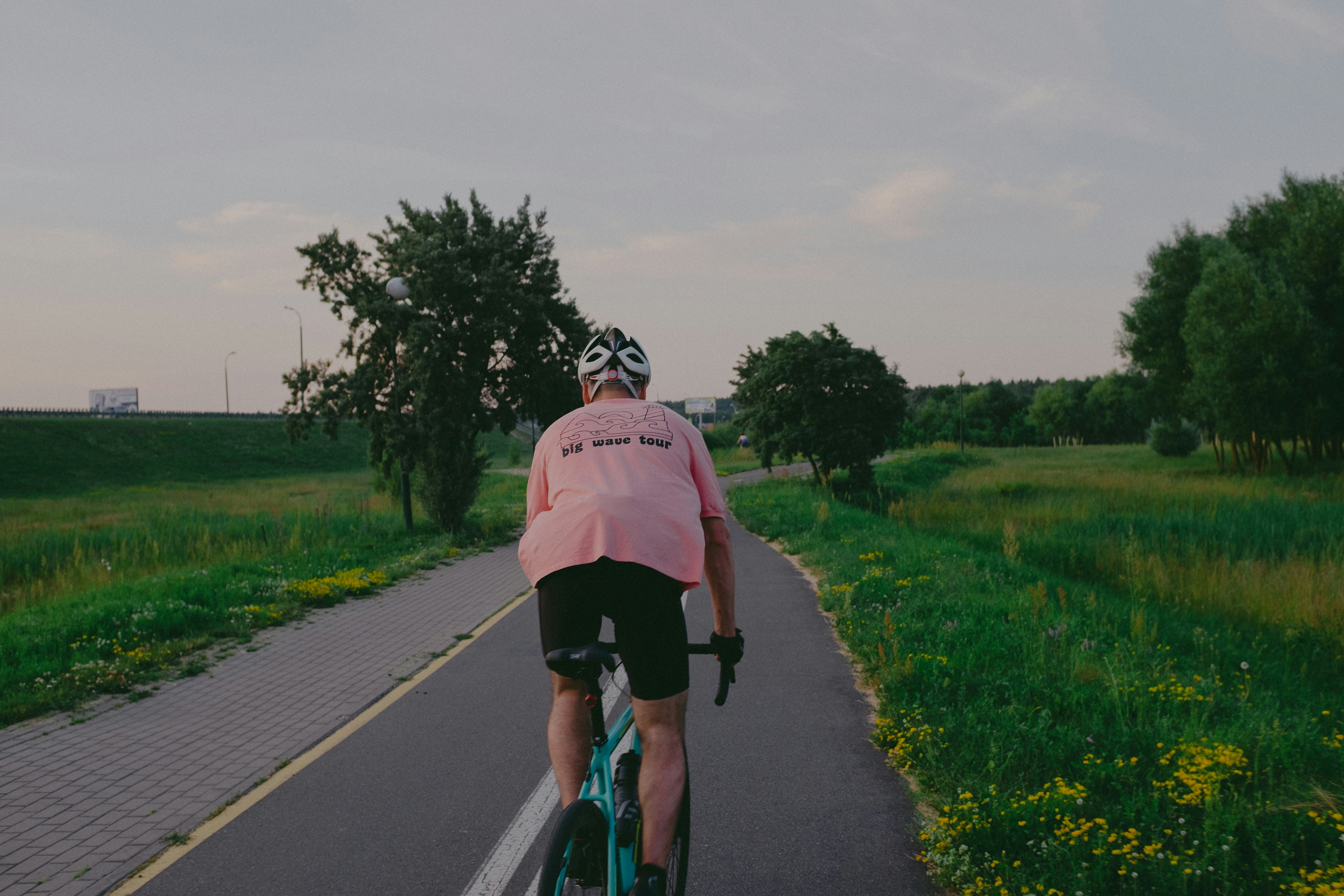 Cyclist riding a road bike outdoors in real conditions.