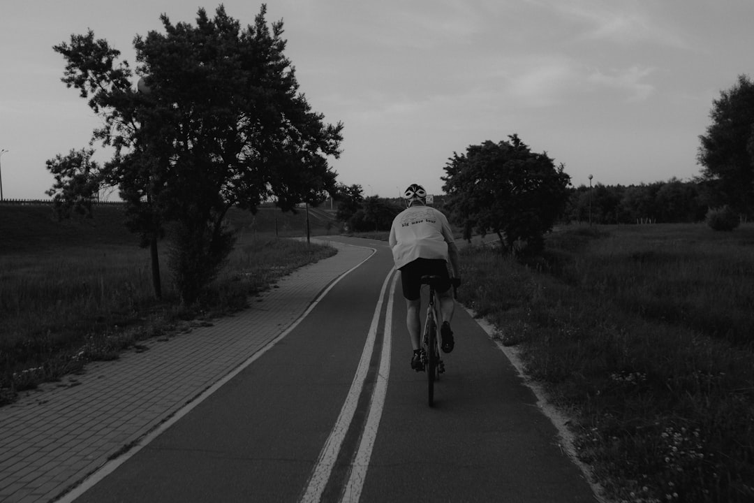 Group of road cyclists riding together outdoors on paved roads.