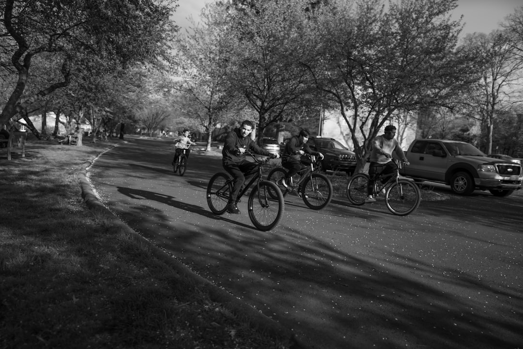 Group of road cyclists riding together outdoors on paved roads.