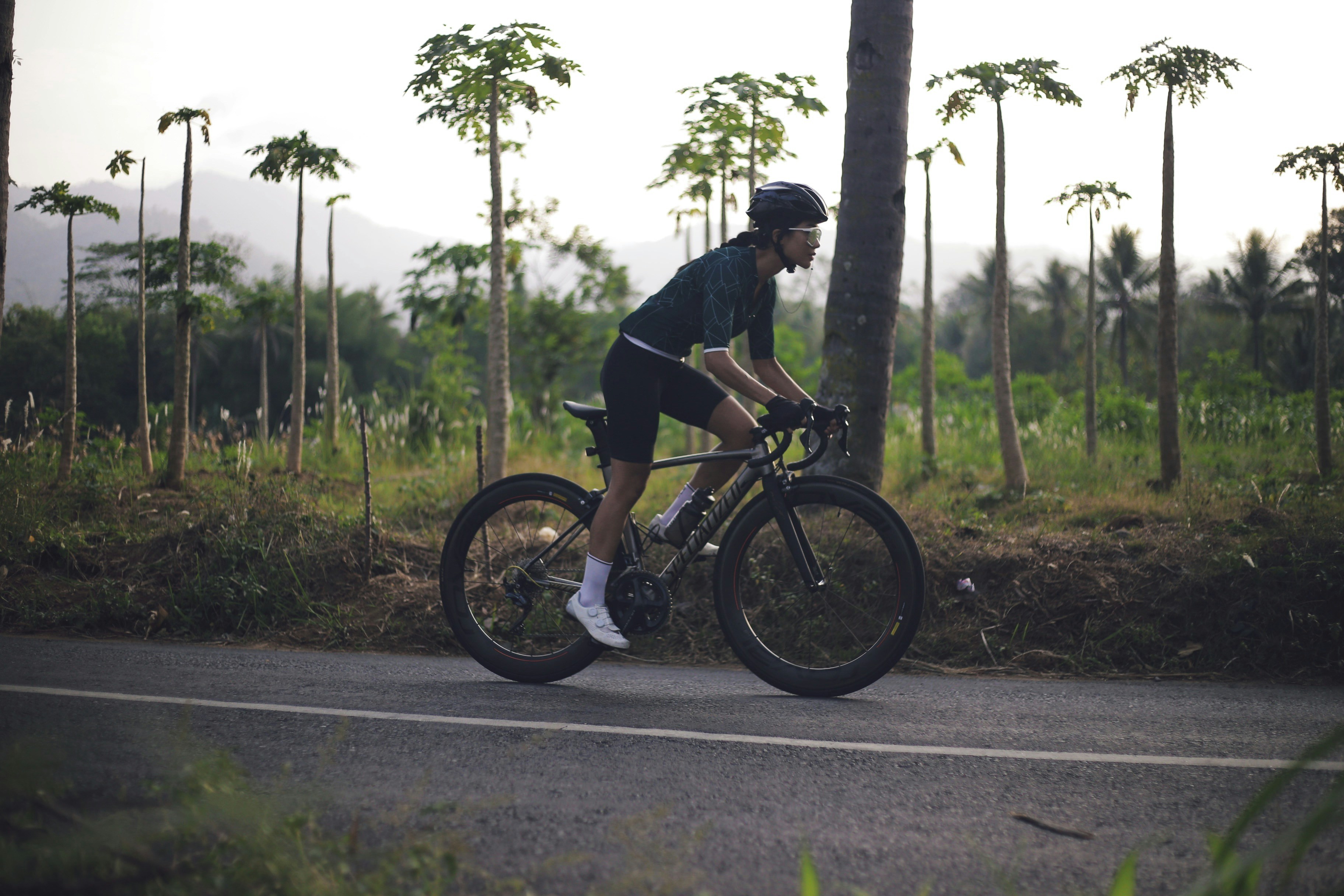 Cyclist riding a road bike outdoors in real conditions.