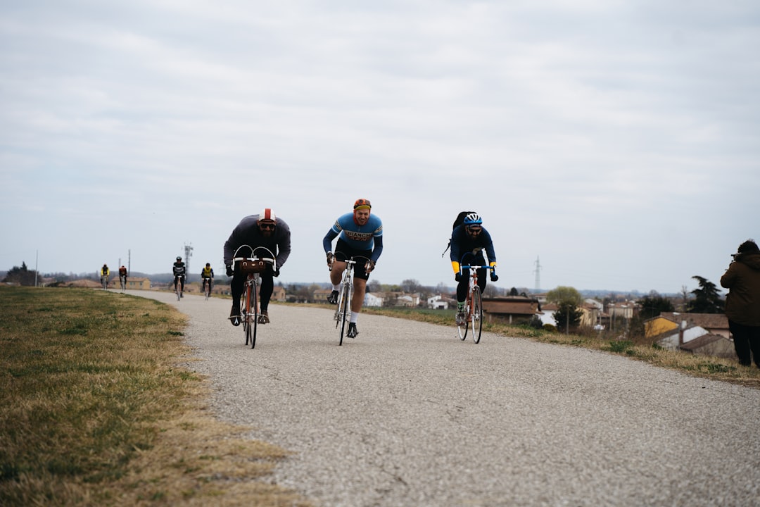 Group of road cyclists riding together outdoors on paved roads.