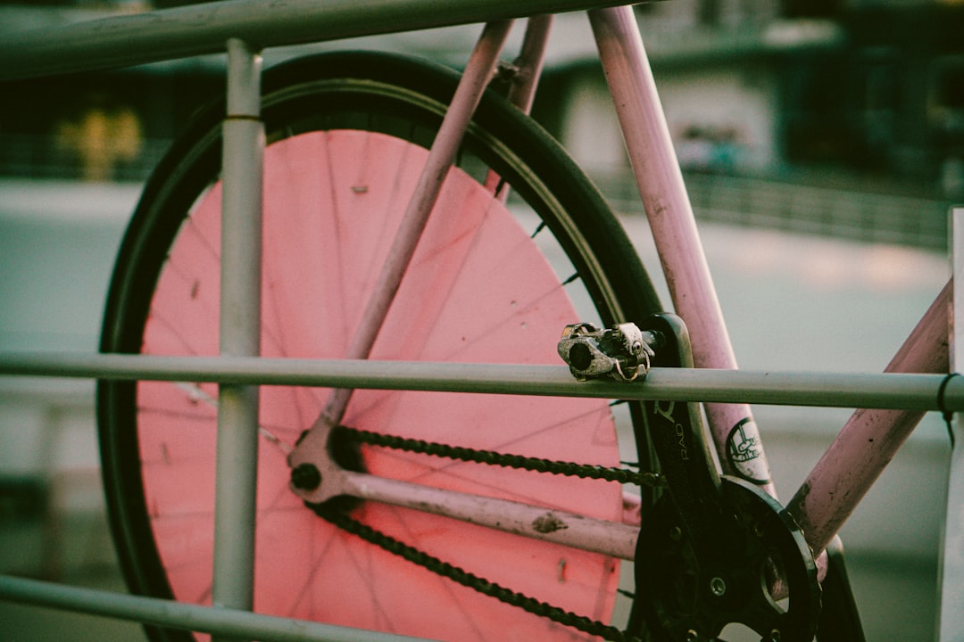 Close-up of a cyclist pedaling on a road bike with a power meter visible.