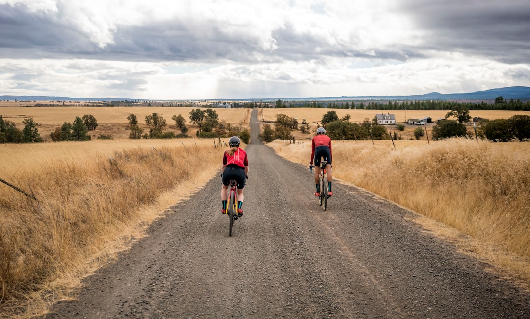 Group of road cyclists riding together outdoors on paved roads.