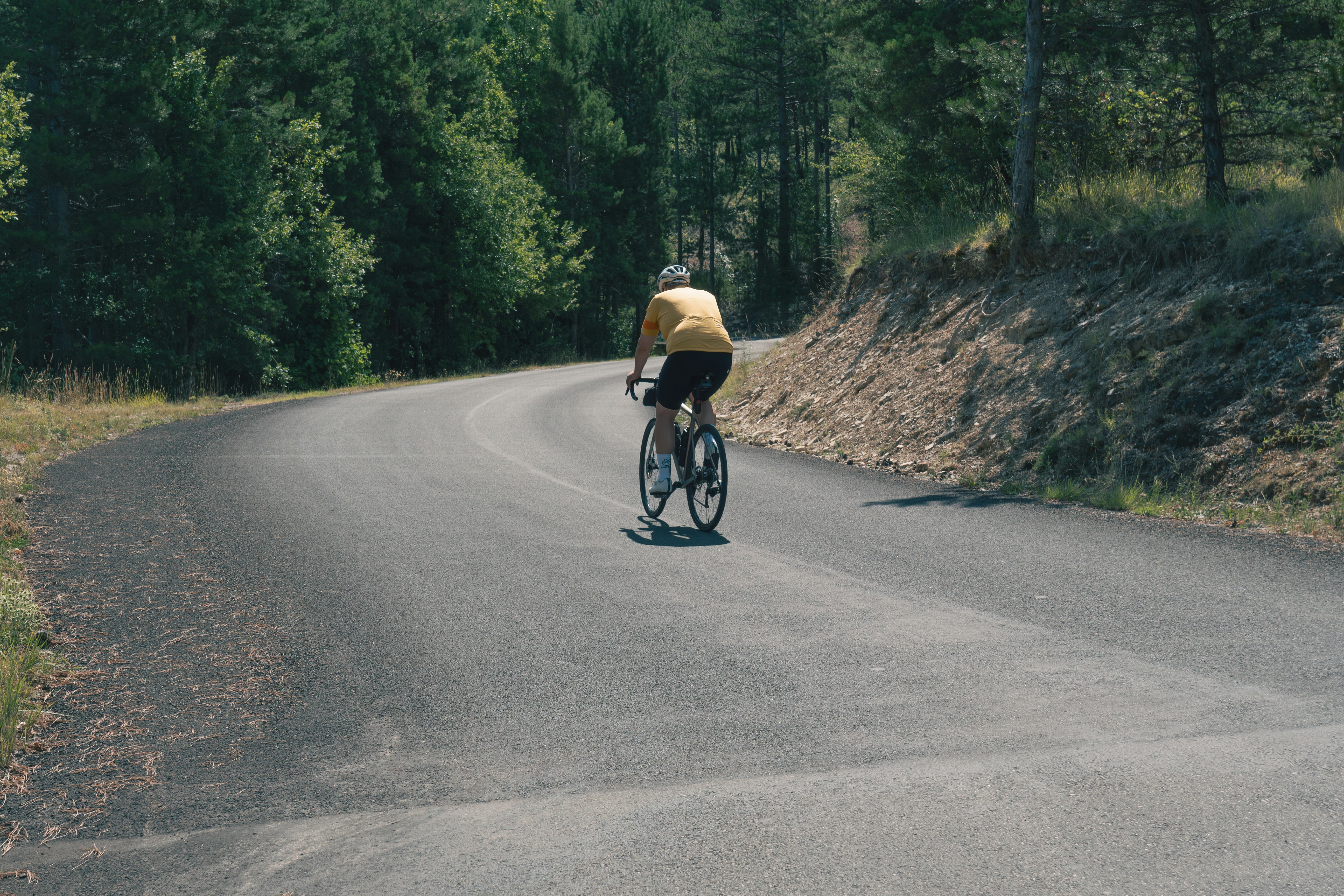 Cyclist riding a road bike outdoors in real conditions.