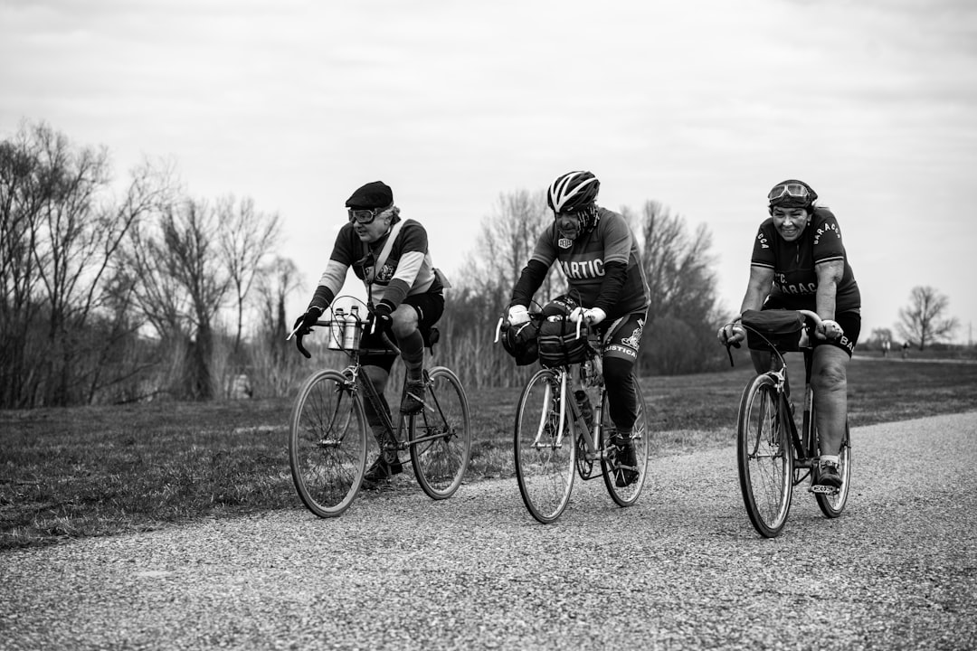 Group of road cyclists riding together outdoors on paved roads.
