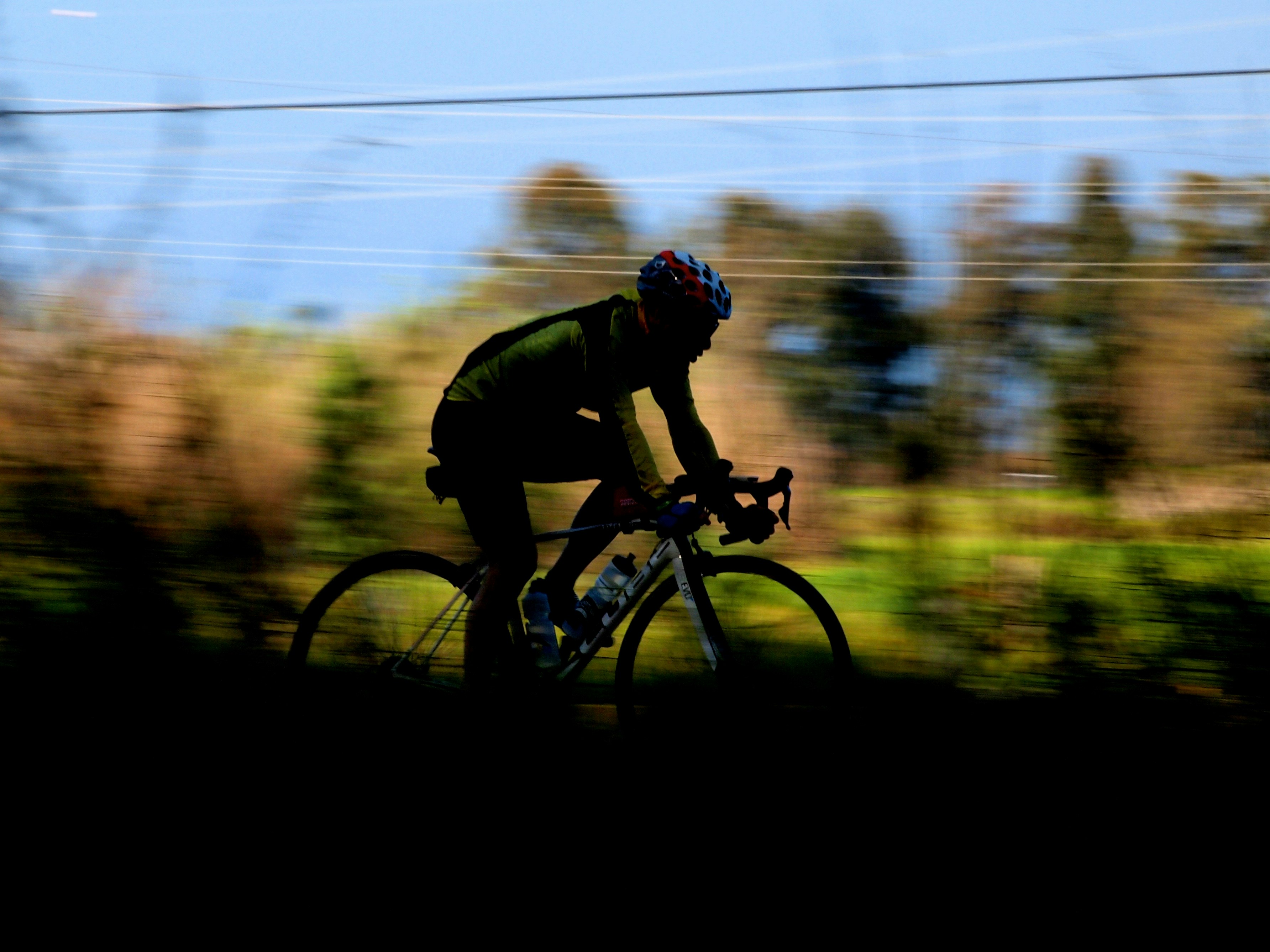 Cyclist riding a road bike outdoors in real conditions.