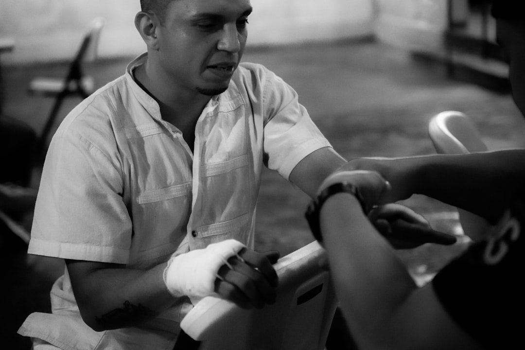 Close-up of a cyclist pedaling on a road bike with a power meter visible.