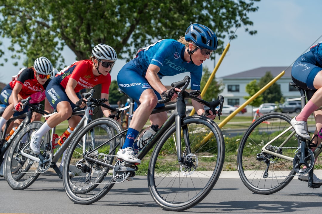 Group of road cyclists riding together outdoors on paved roads.