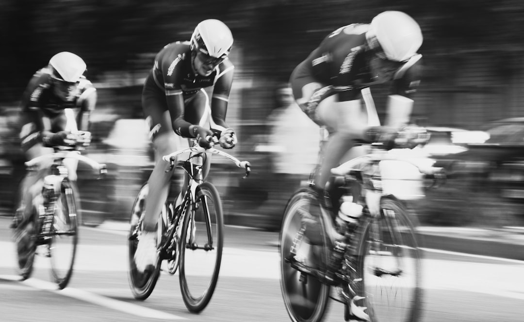 Group of road cyclists riding together outdoors on paved roads.