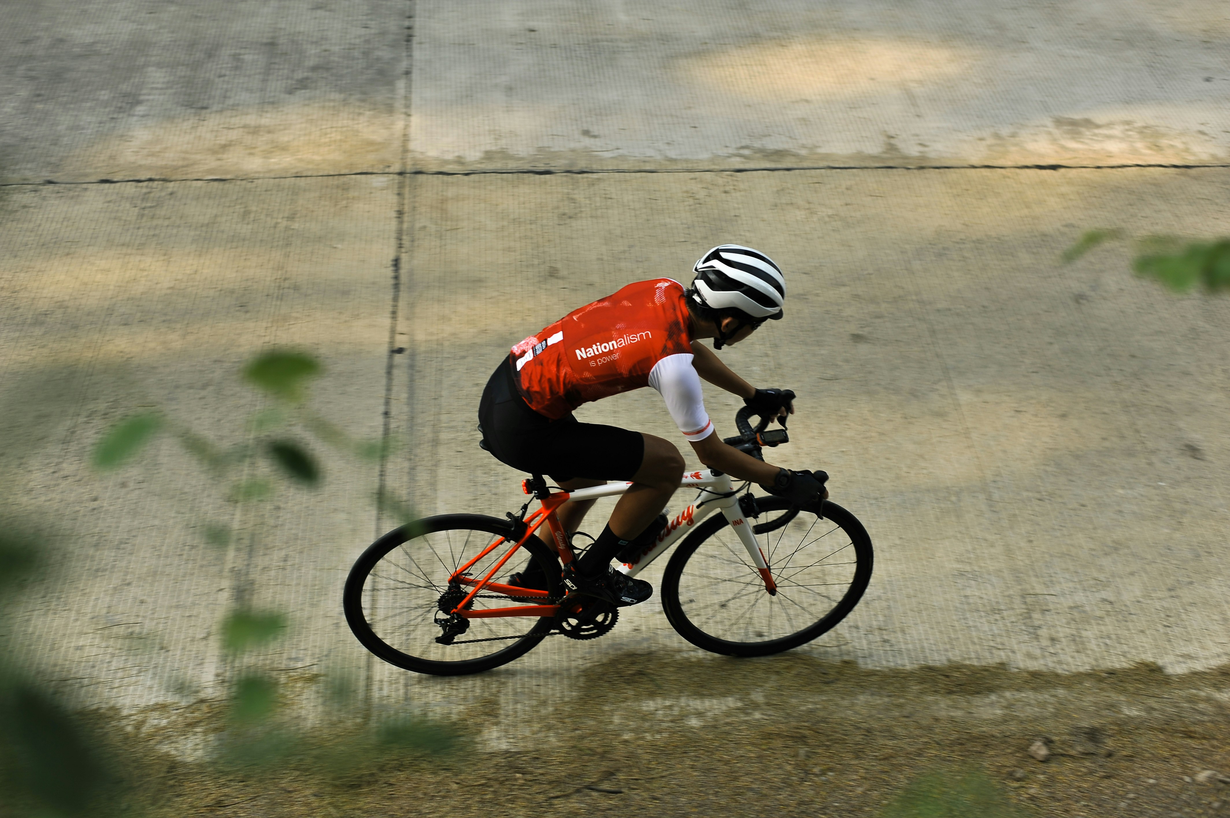 Cyclist riding a road bike outdoors in real conditions.