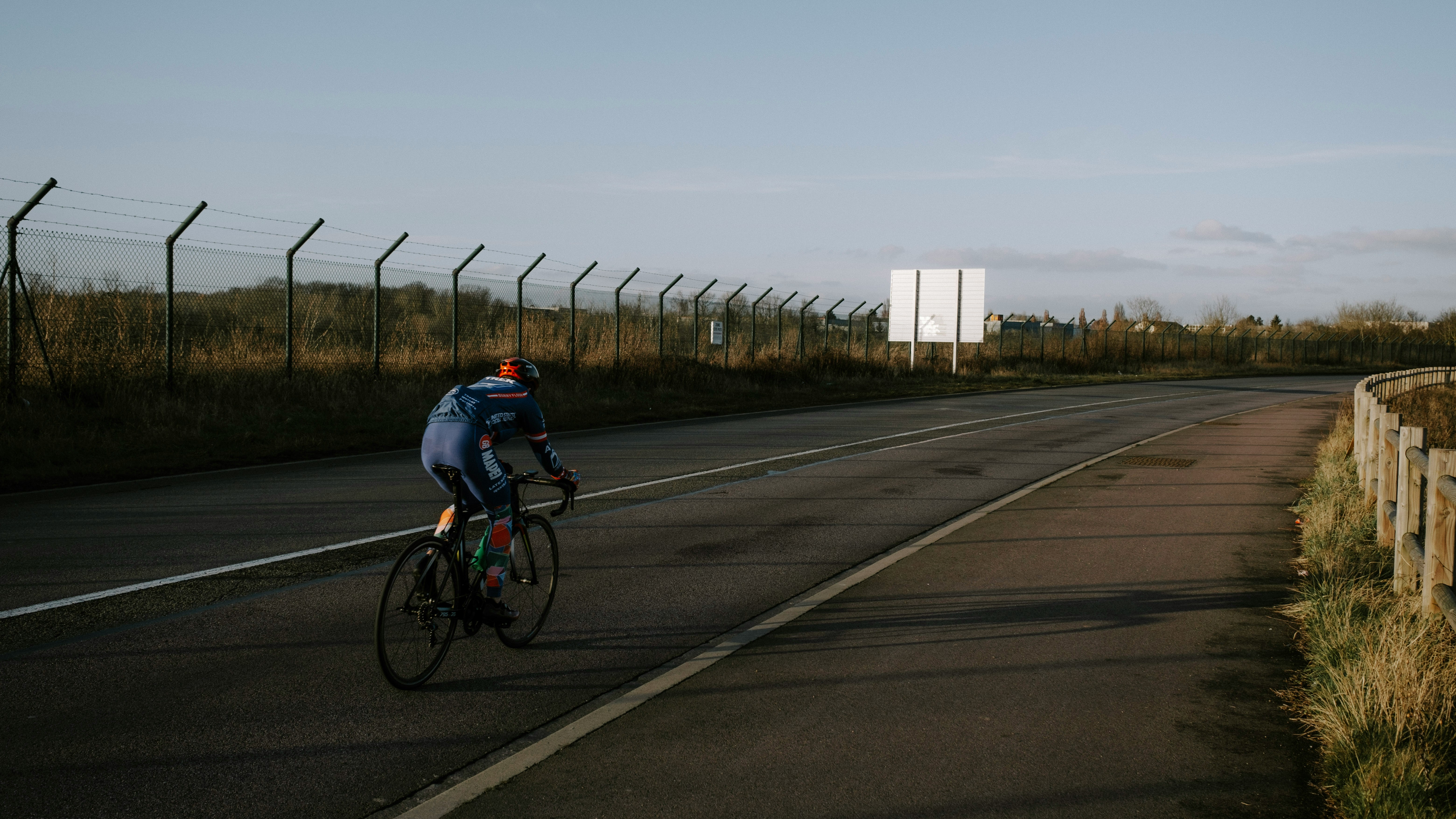 Cyclist riding a road bike outdoors in real conditions.