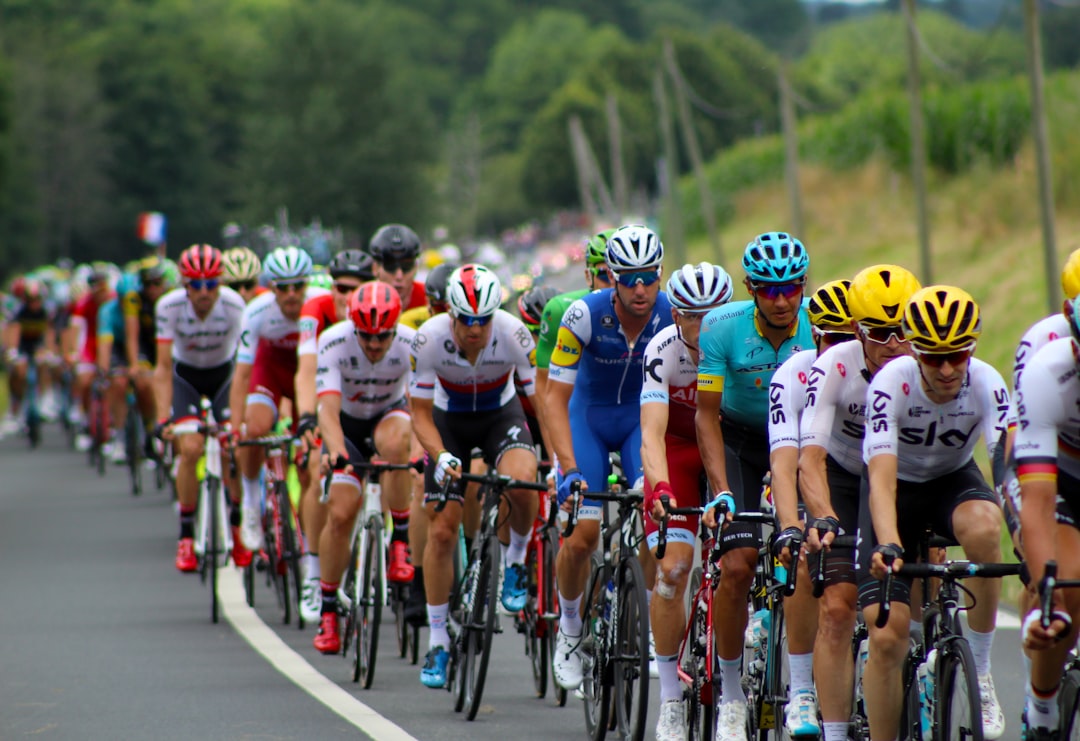 Group of road cyclists riding together outdoors on paved roads.