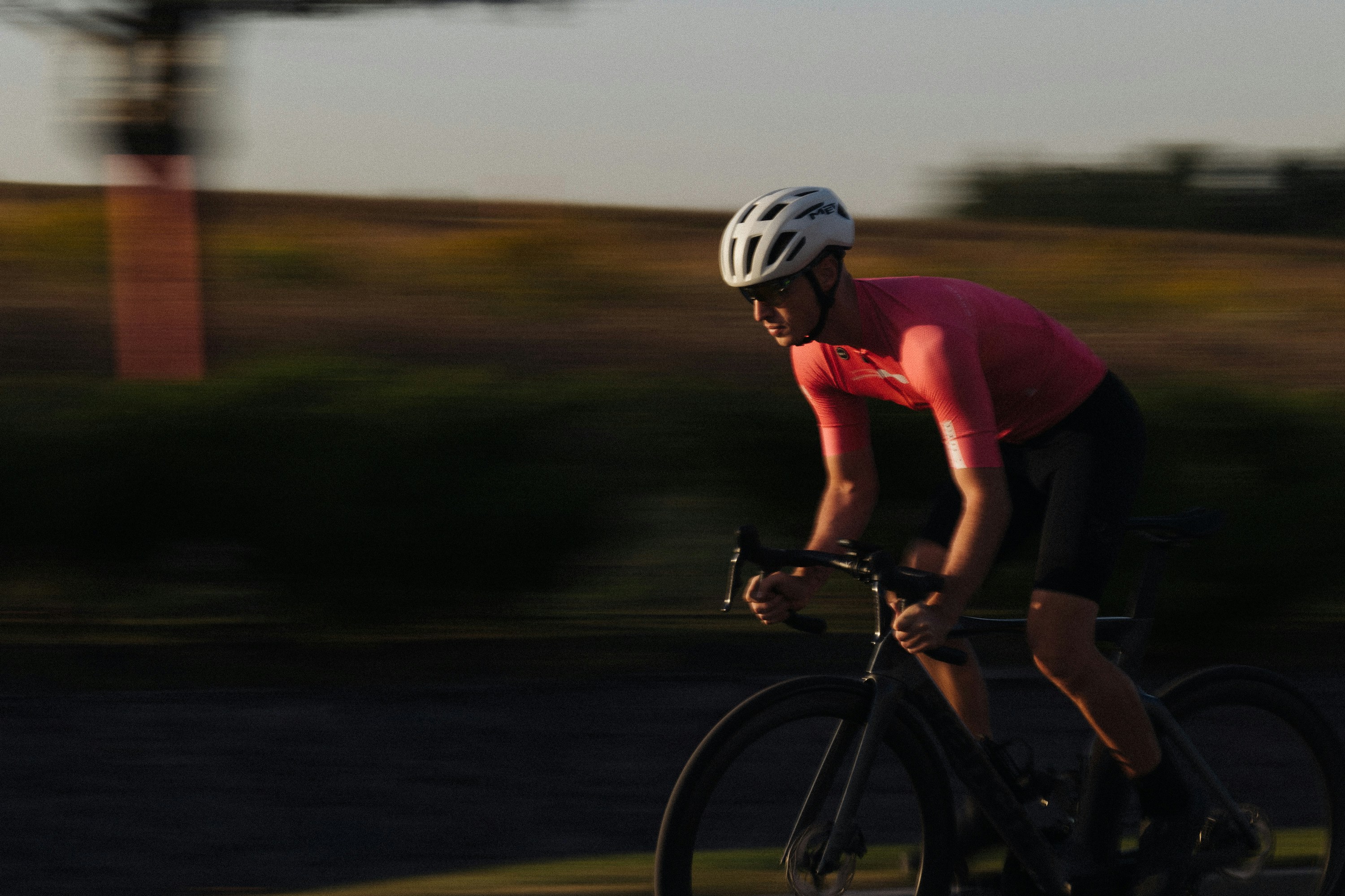 Cyclist riding a road bike outdoors in real conditions.