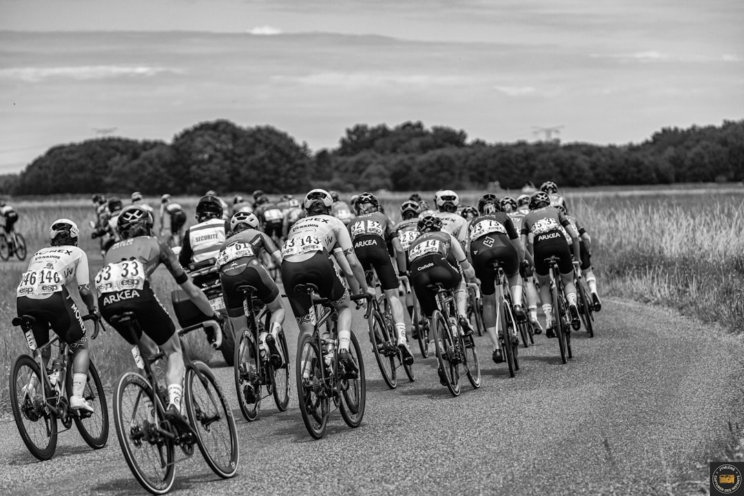 Group of road cyclists riding together outdoors on paved roads.