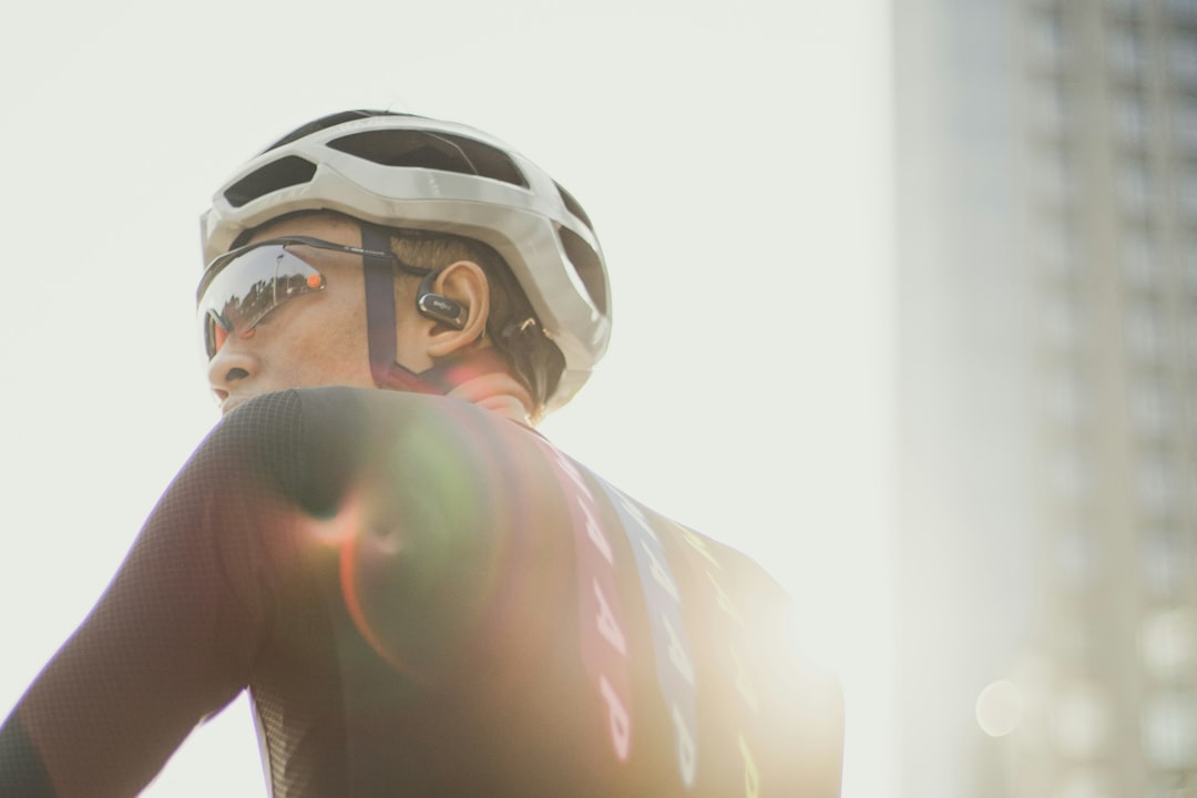 Close-up of a cyclist pedaling on a road bike with a power meter visible.