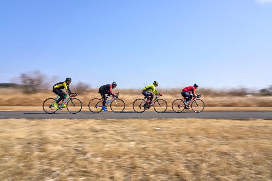 Group of road cyclists riding together outdoors on paved roads.