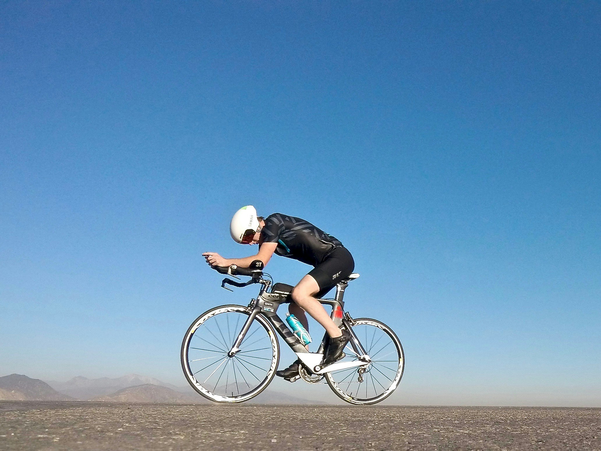 Cyclist riding a road bike outdoors in real conditions.
